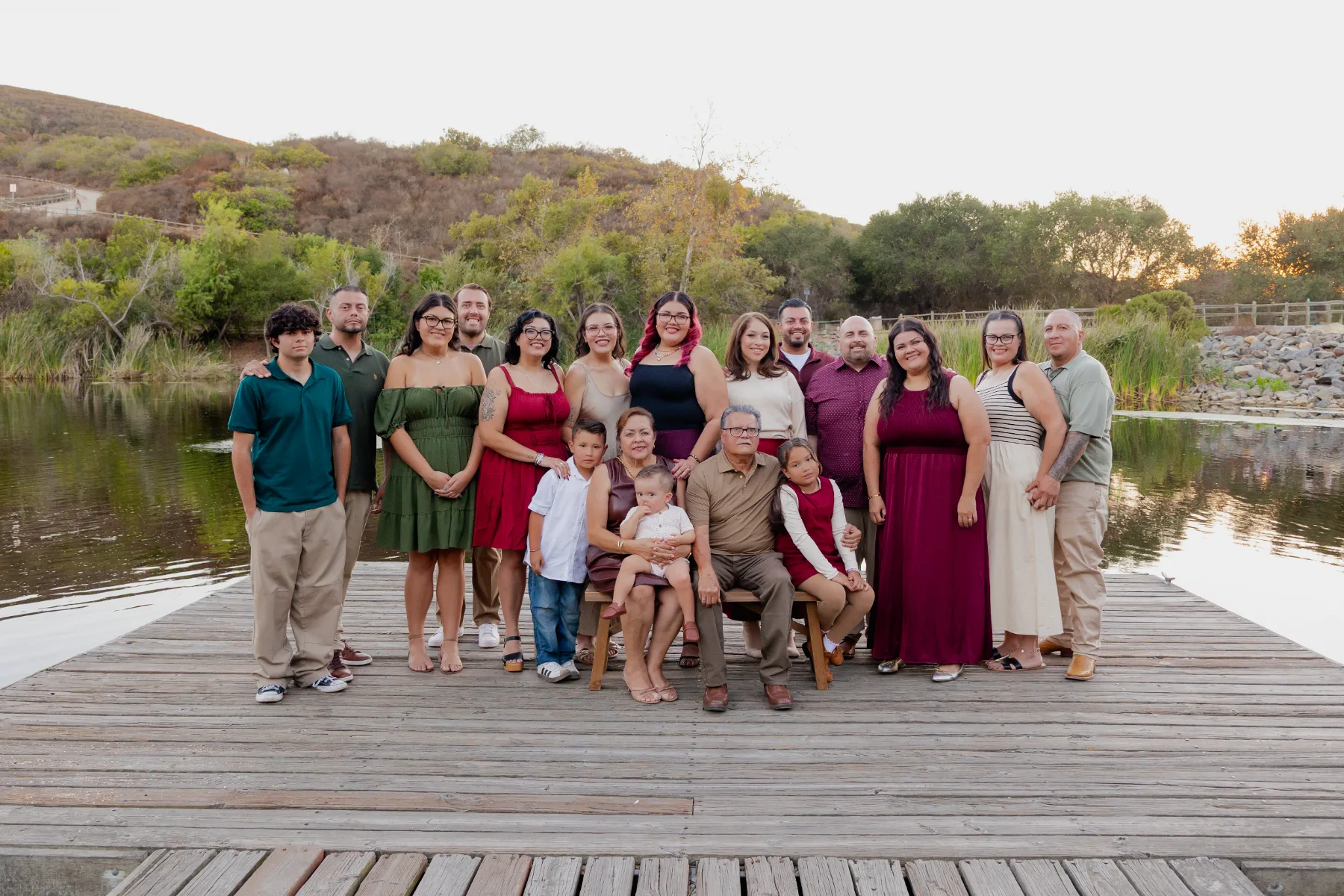 Extended family on a wooden boardwalk at golden hour, JSOLOVISUALS