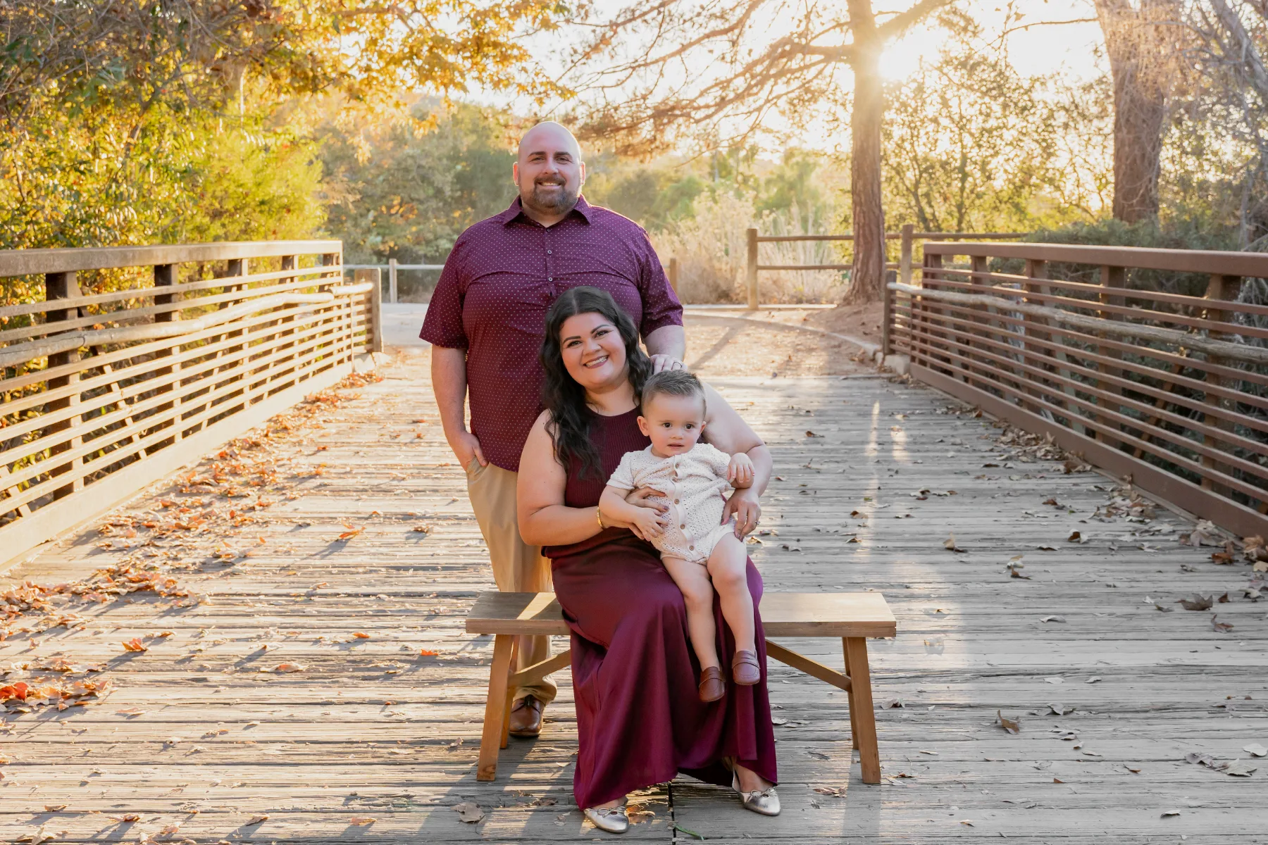 Family on a bench at the end of a boardwalk at sunset, JSOLOVISUALS
