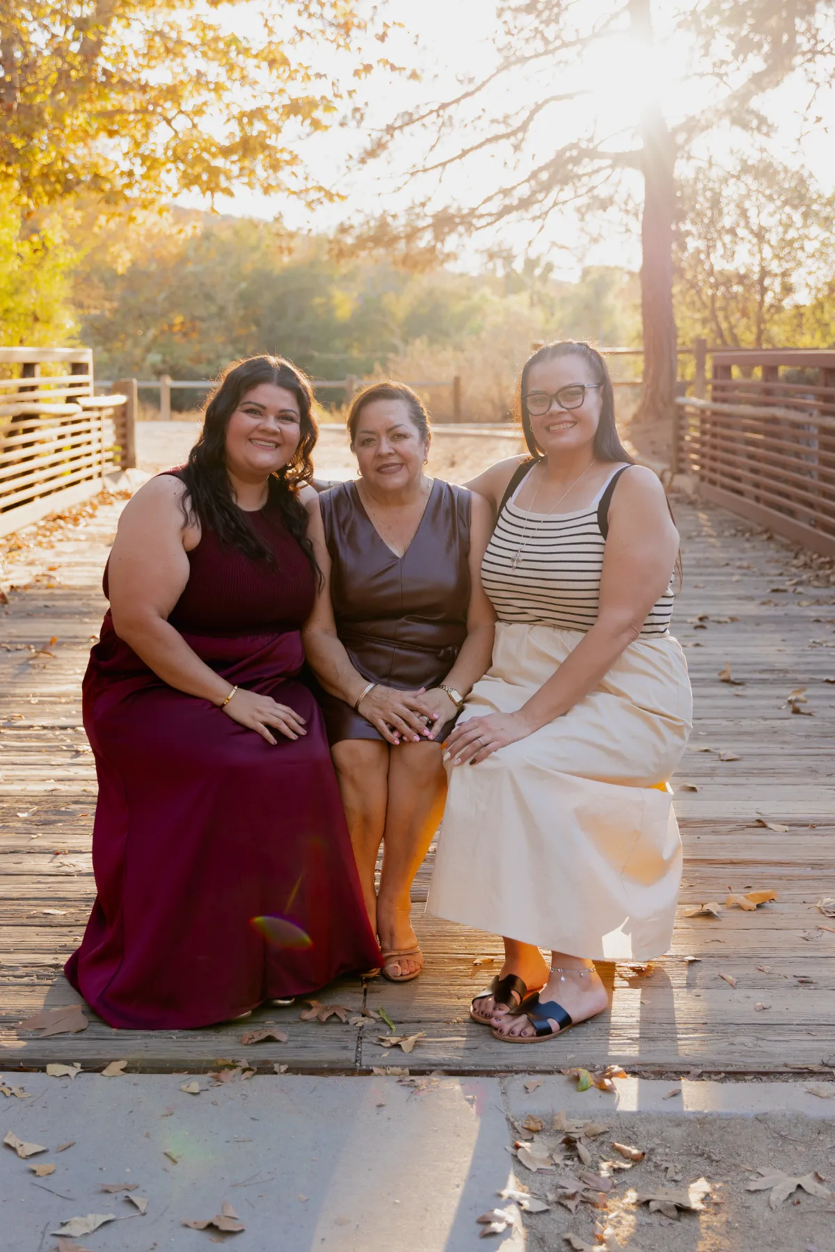 Three generations of women, mother, daughter and grandmother, photographed outdoors at golden hour by JSOLOVISUALS