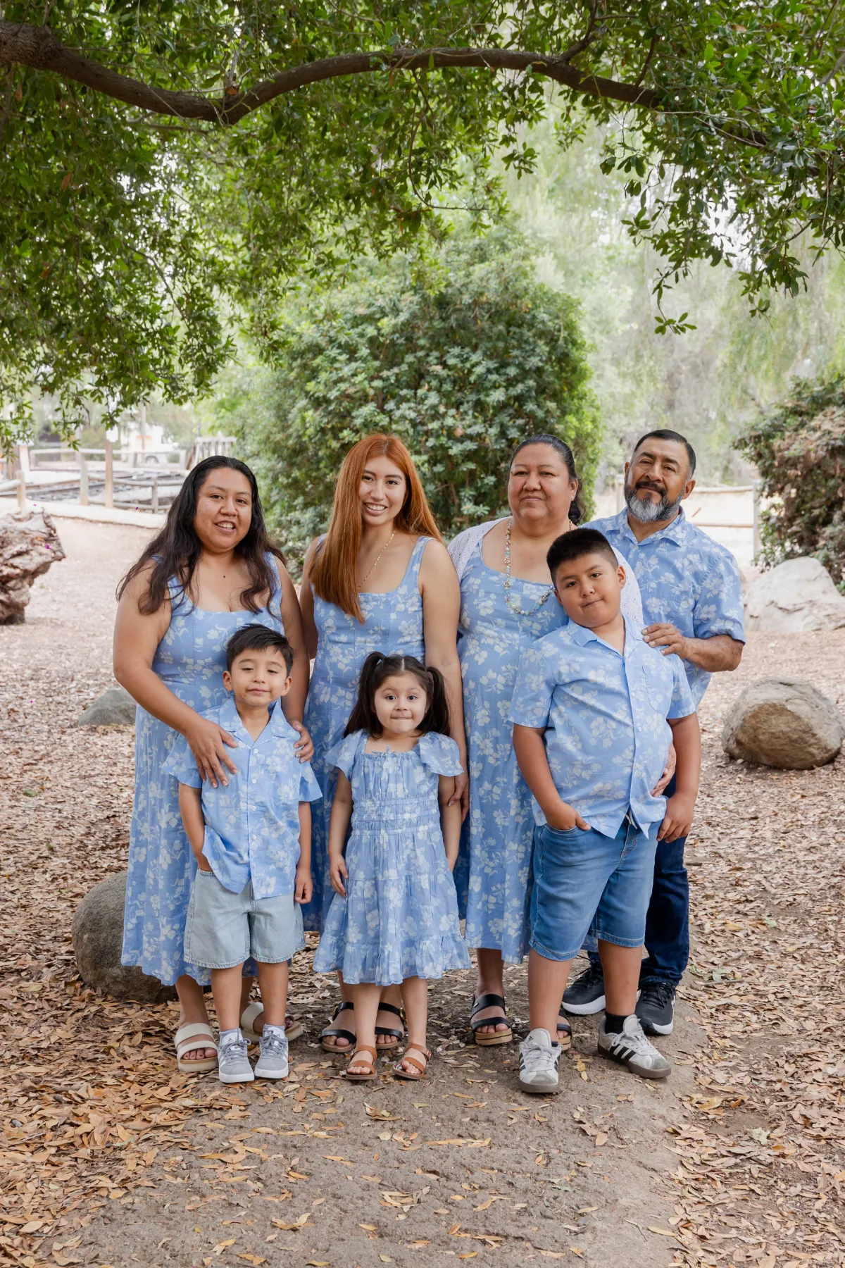 Grandmother, daughters and grandchildren in matching blue florals, JSOLOVISUALS