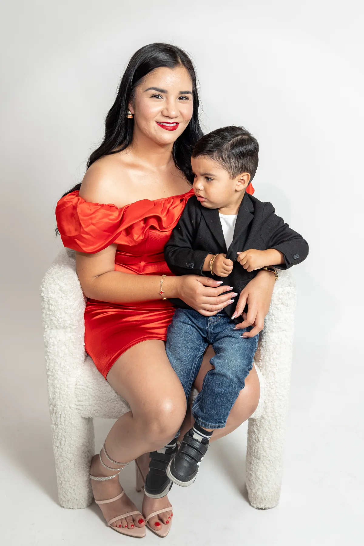 Mom in a red dress holding her son in the Poway studio, JSOLOVISUALS