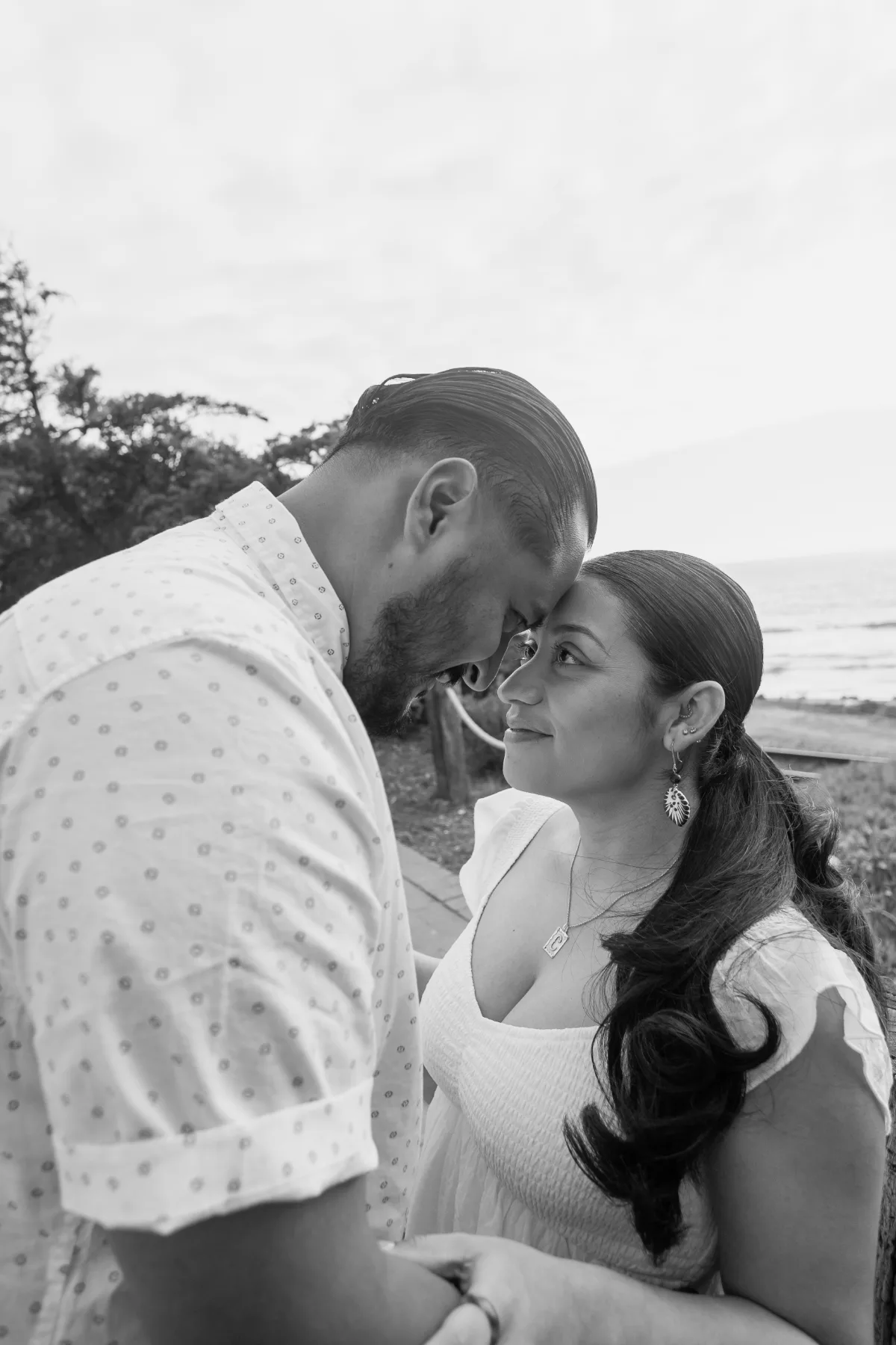 Black and white couple maternity portrait by the ocean