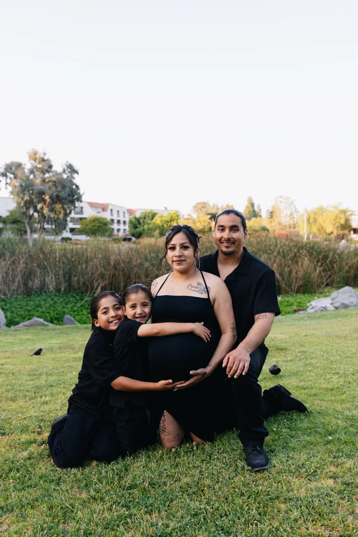 Family of four maternity portrait in a San Diego park